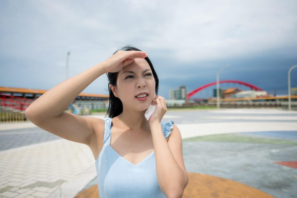 Woman sweating outdoors in Singapore during El Niño heat wave